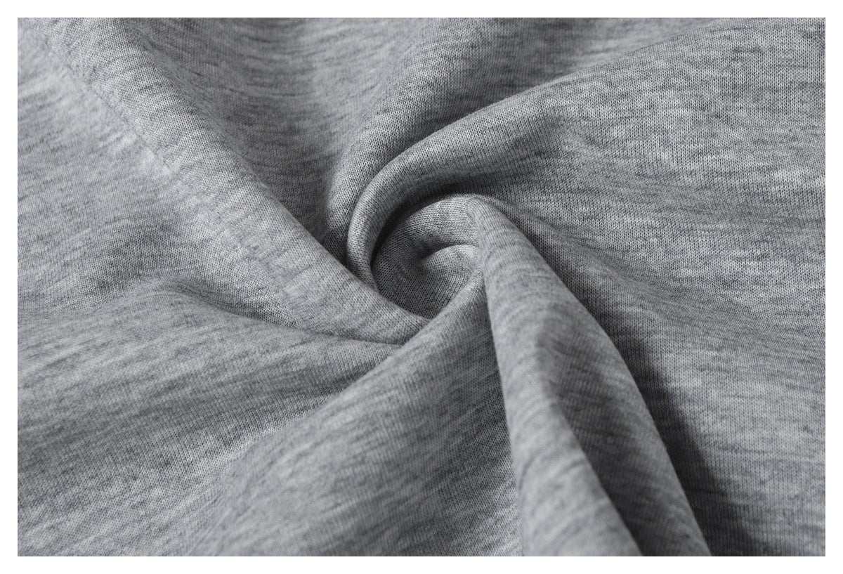 Close-up of gray heathered knit fabric draped into soft folds.