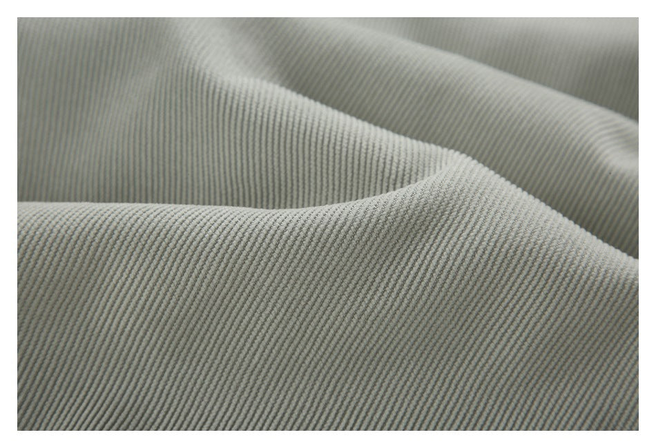 Close-up of gray ribbed fabric folded to show its raised linear texture.