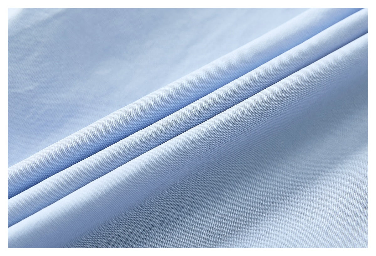Close-up of pale blue fabric arranged in soft folds.