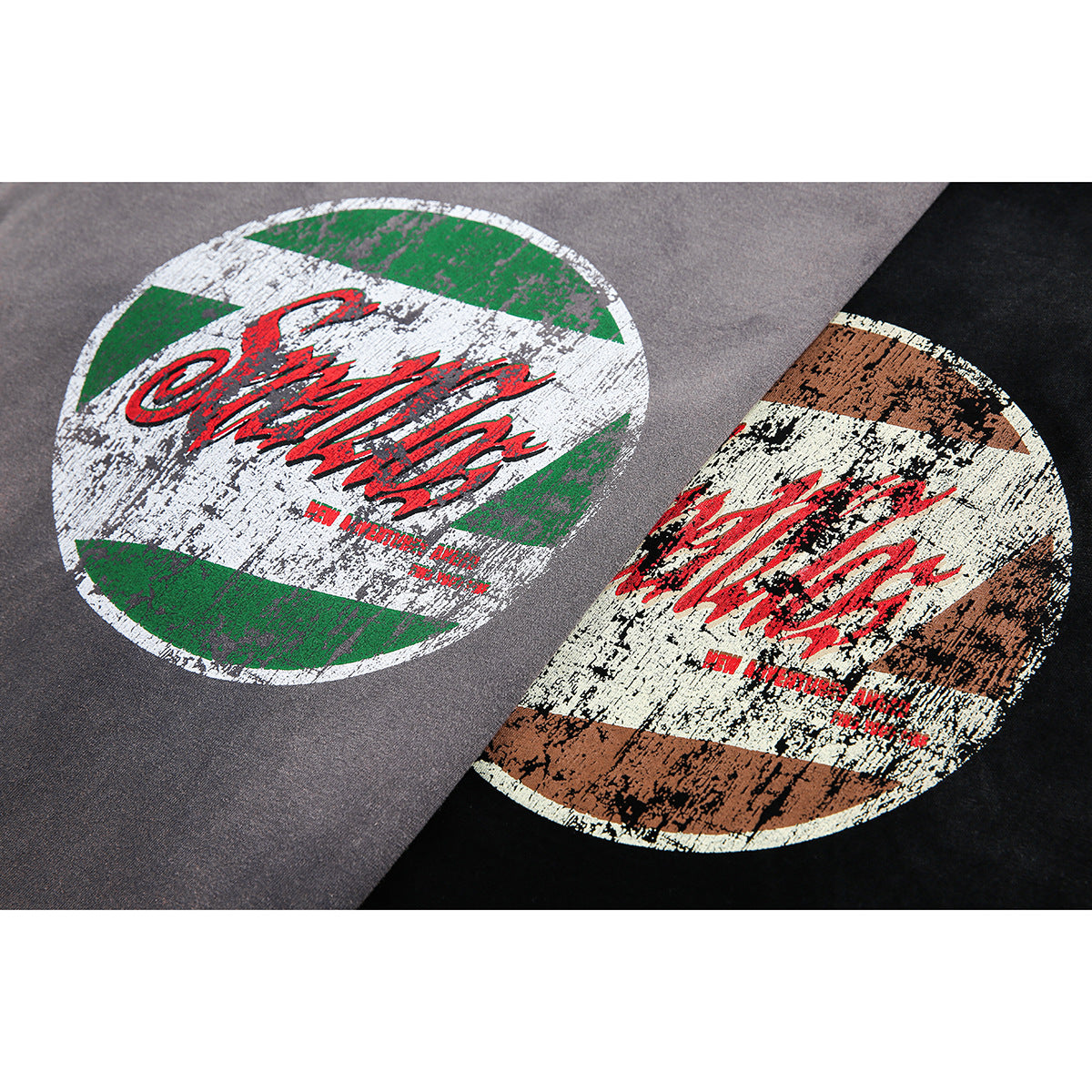 Close-up of distressed circular chest graphics in green and white on gray, and brown and cream on black.