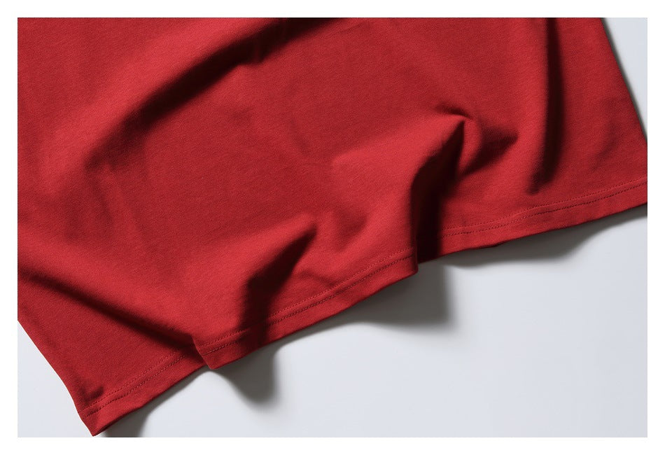 Close-up of the red shirt's lower hem with visible double stitching.