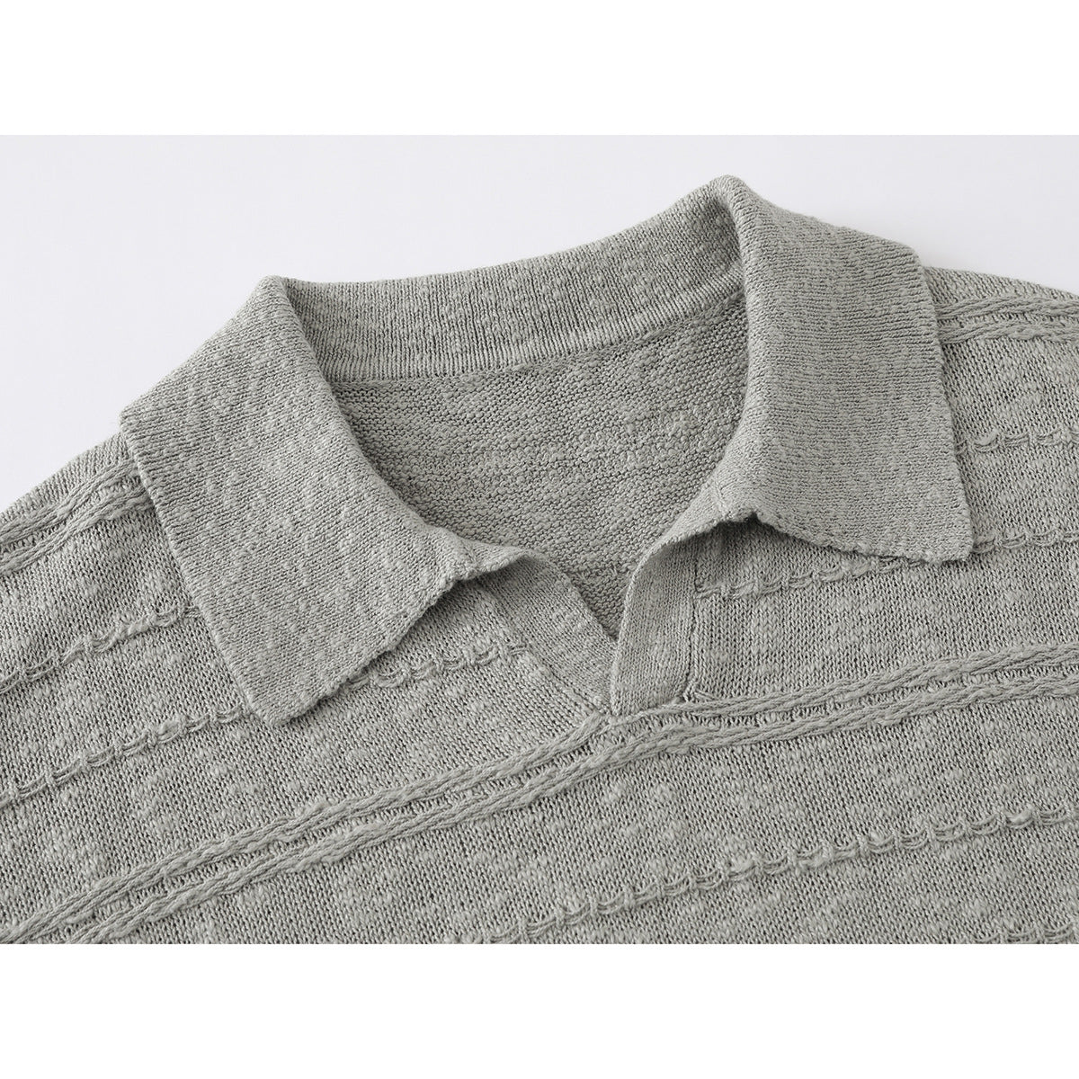 Close-up of a light gray knit polo shirt collar and textured horizontal bands.