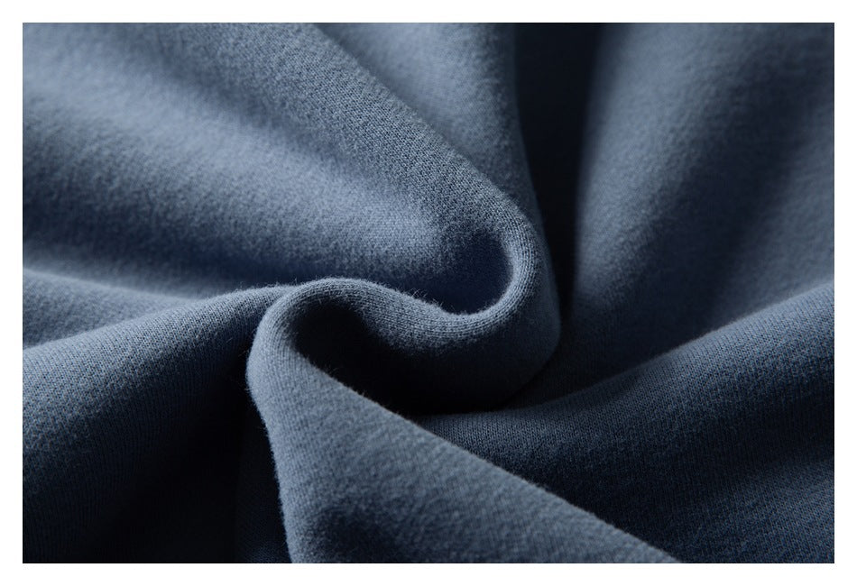 Macro view of the blue garment fabric gathered into soft folds.