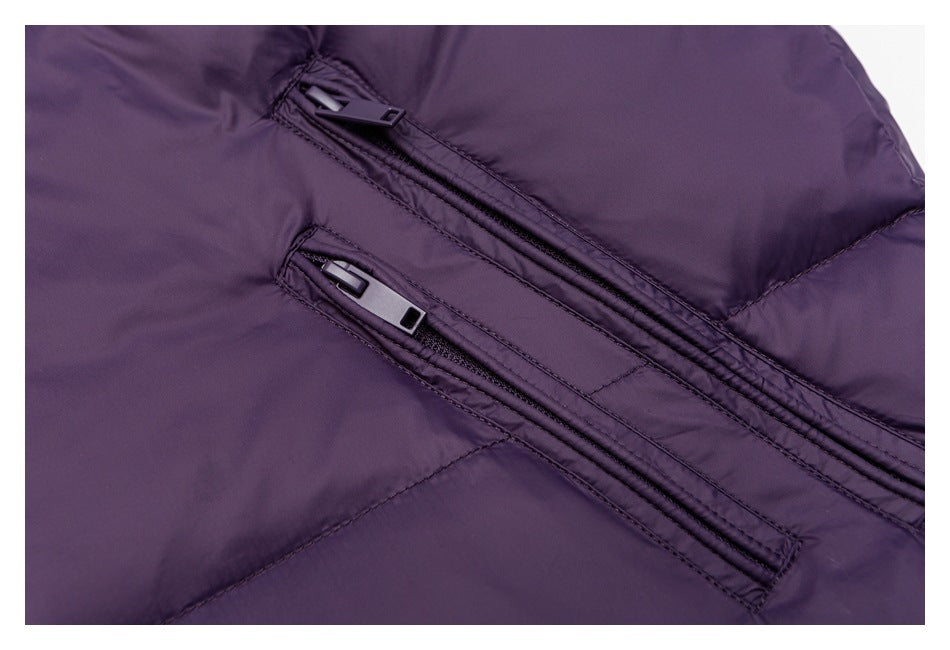 Close-up of two zippered pockets and stitched seams on a deep purple puffer jacket.