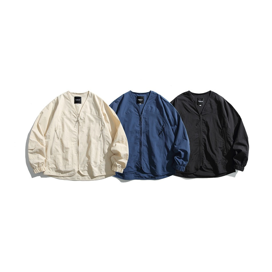 Three front-facing jackets displayed side by side in cream, blue and black.