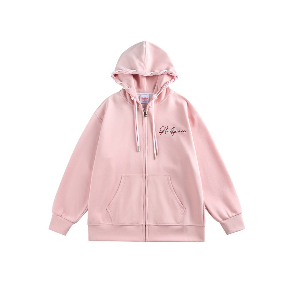 Pink zip-front hoodie flat lay with white drawstrings, kangaroo pocket and script chest embroidery