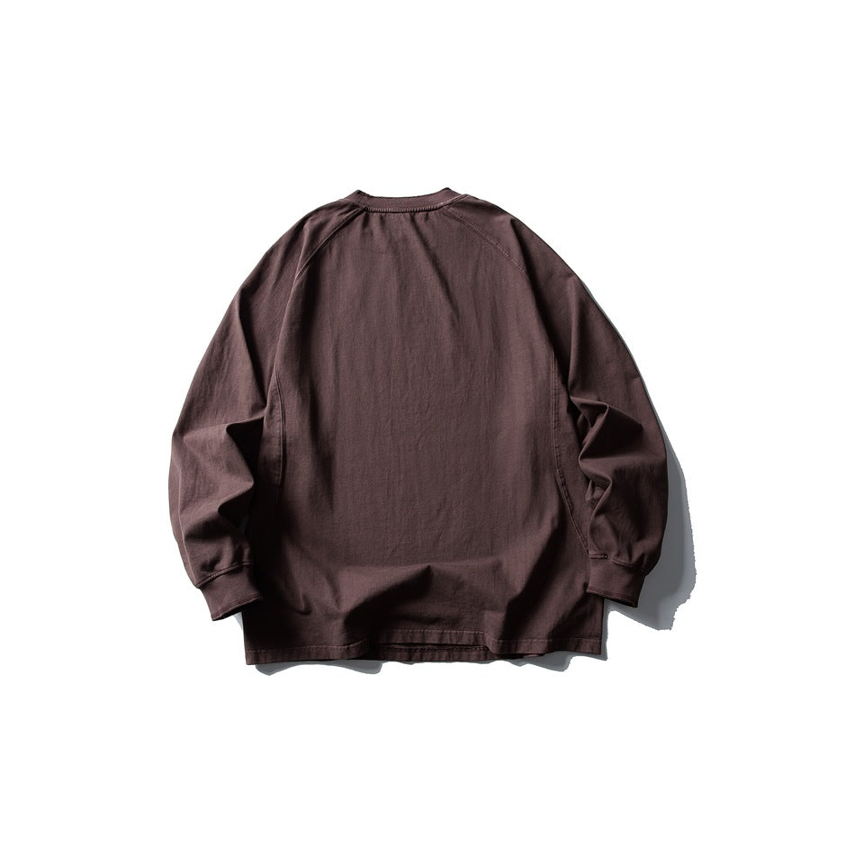 Back view of a muted brown long-sleeve crewneck shirt with raglan sleeves and ribbed cuffs.