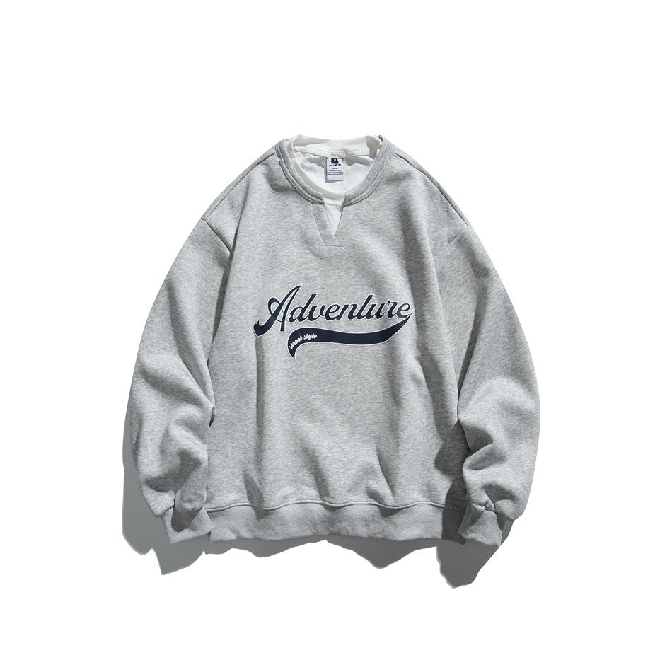 Heather gray crewneck sweatshirt with white under-collar and navy script Adventure graphic, flat lay