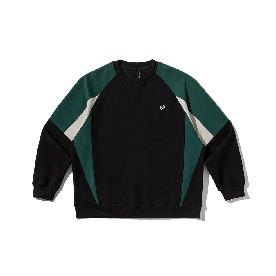 Black crewneck sweatshirt with green and cream colorblock raglan sleeves and small white chest logo, flat lay