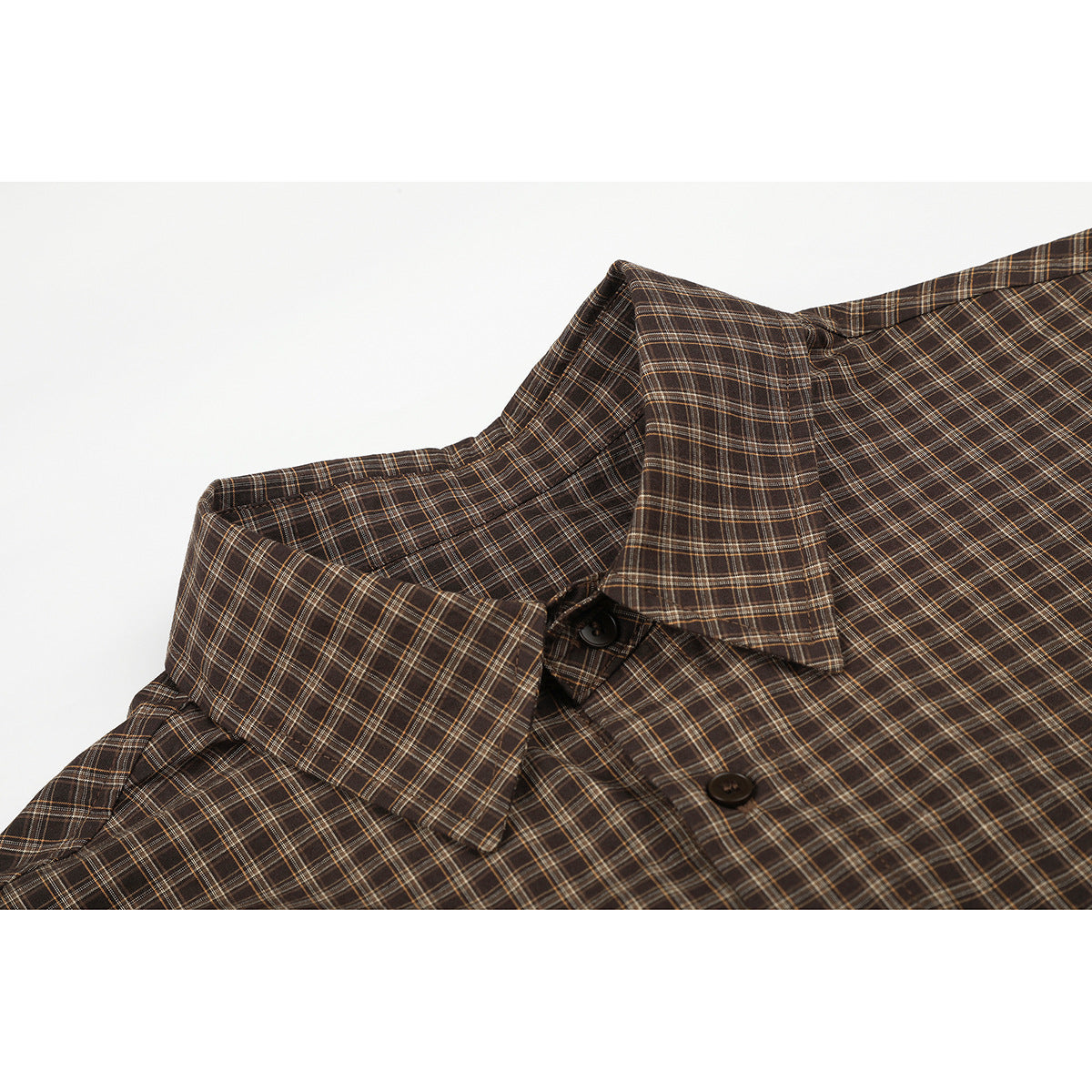 Close-up of a brown plaid shirt collar and dark front buttons.