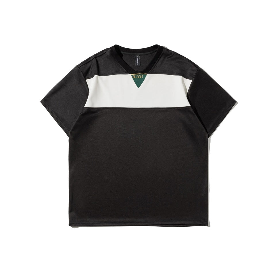 Front view of a black short-sleeve V-neck shirt with a wide white chest stripe and a small green chest emblem.
