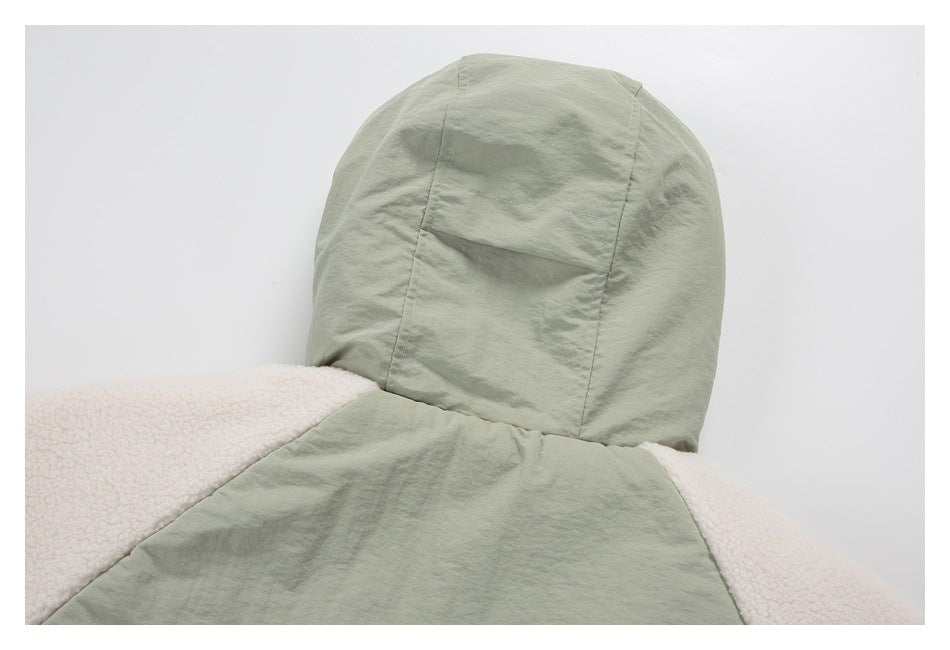 Close-up of the back of a sage green hooded jacket with cream sherpa panels.