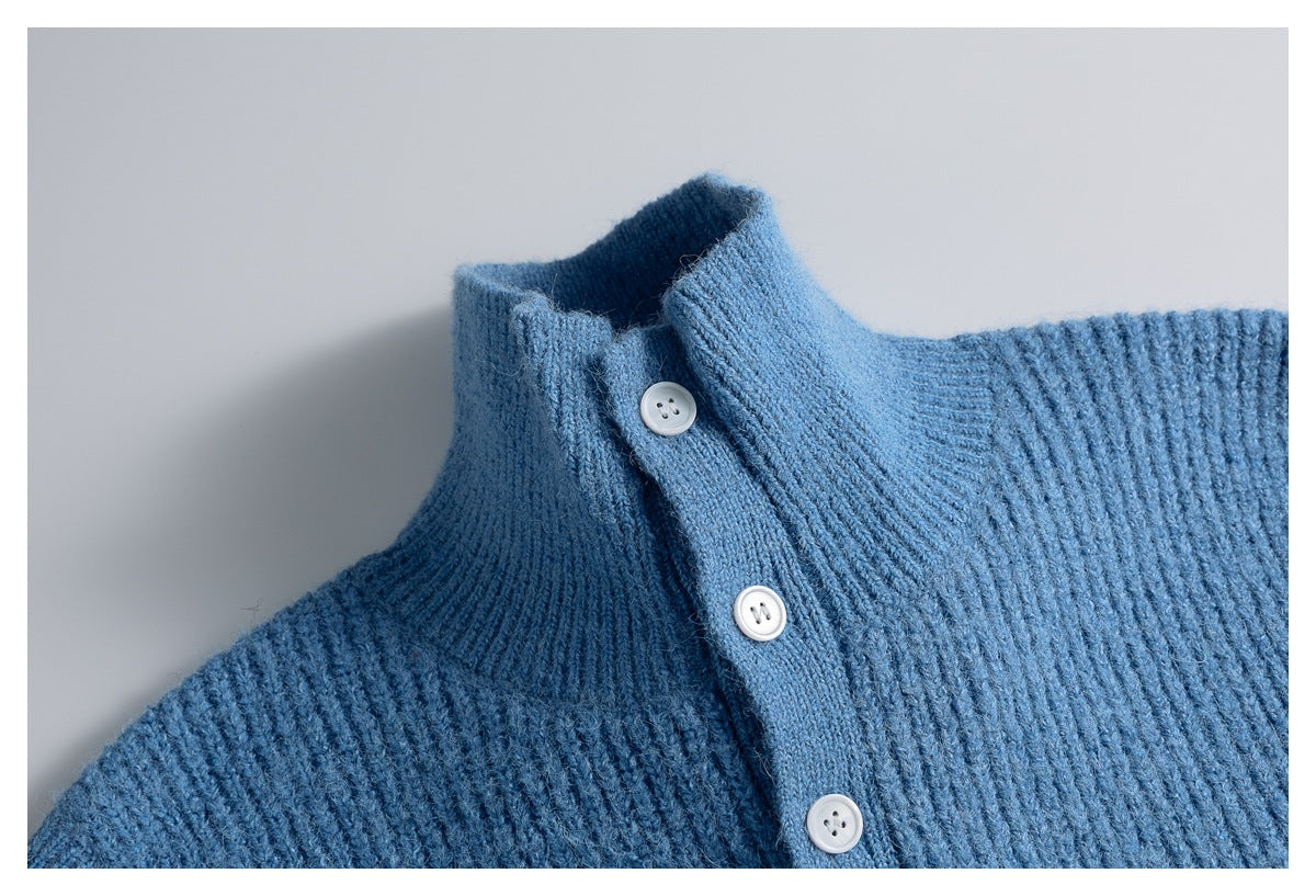 Close-up of the blue knit vest's ribbed collar, shoulder and white-button placket.
