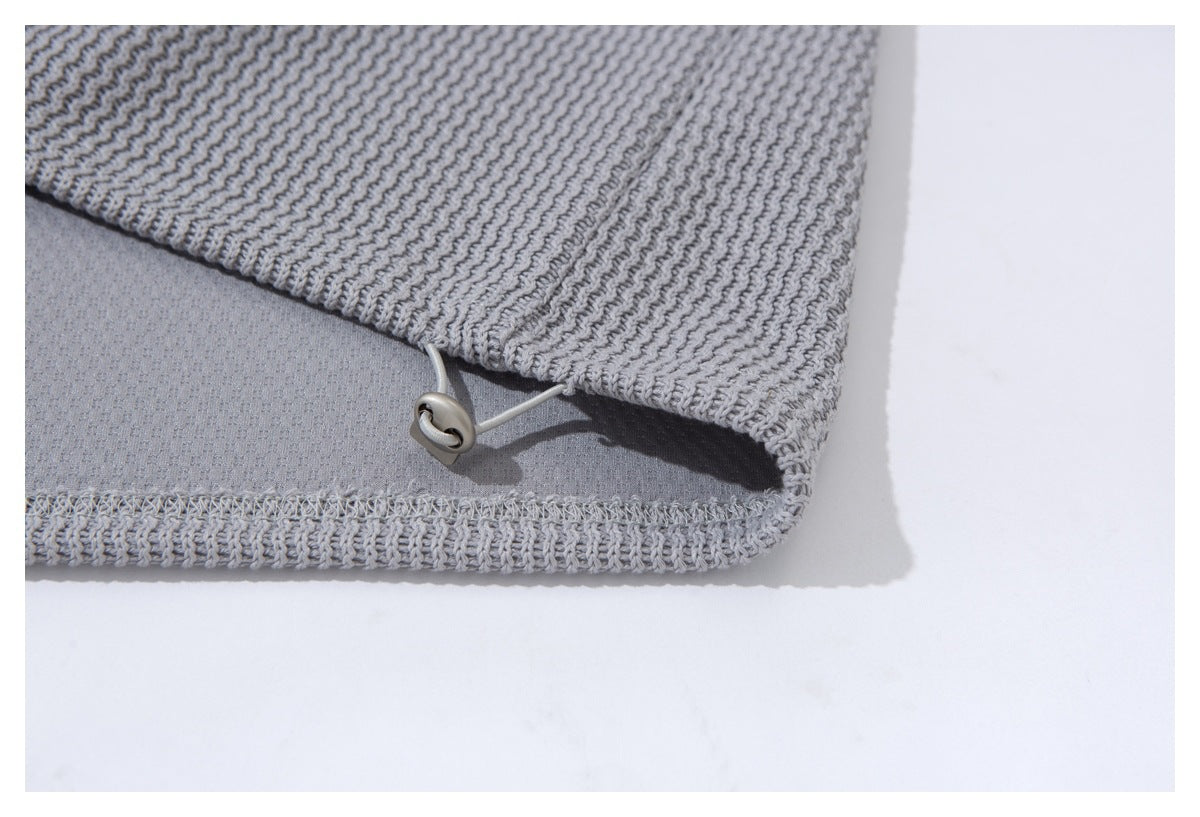 Close-up of the cardigan hem underside with stitching and a small loop fastener.