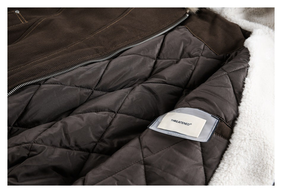 Close-up of a dark brown jacket’s quilted lining, zipper, and sewn-in label.