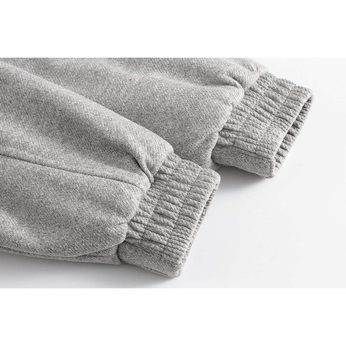Close-up of the gray jacket's sleeves and gathered elastic cuffs.