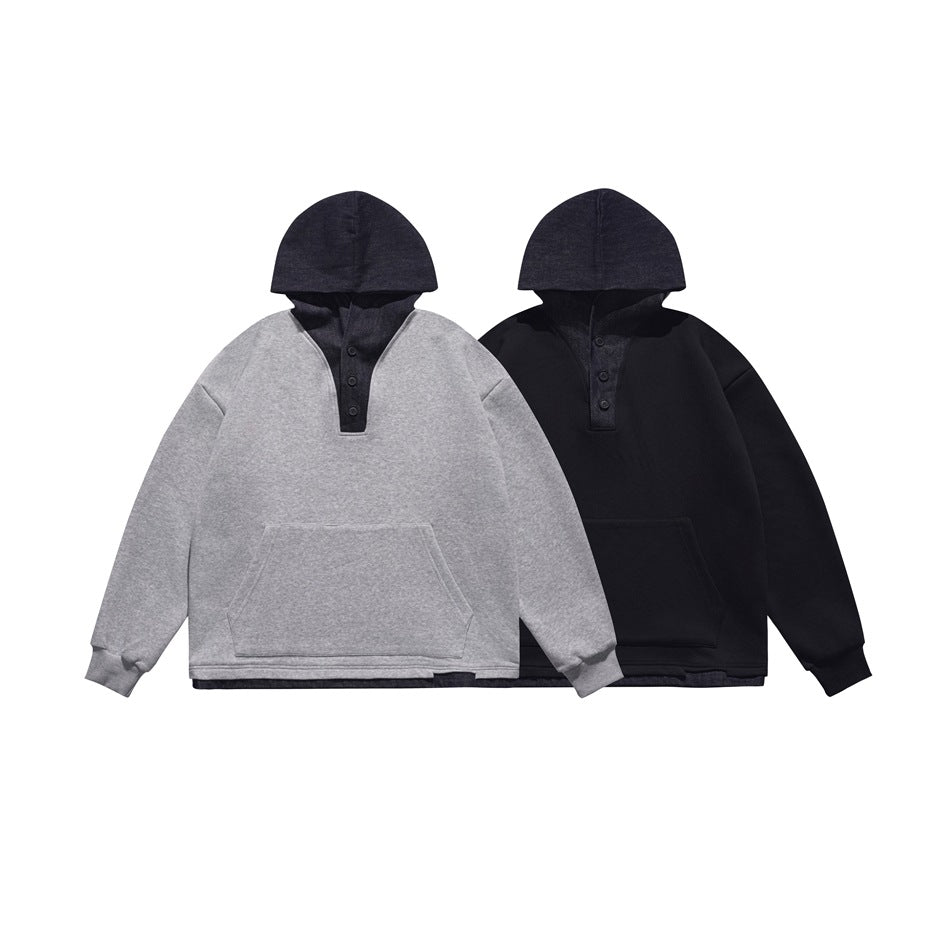 Front view of two hooded pullovers: one gray with a dark hood and one all dark, both with button plackets and kangaroo