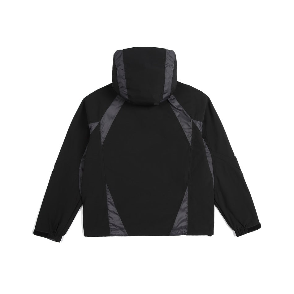 Rear view of a black hooded jacket with charcoal contrast panels and gathered cuffs.
