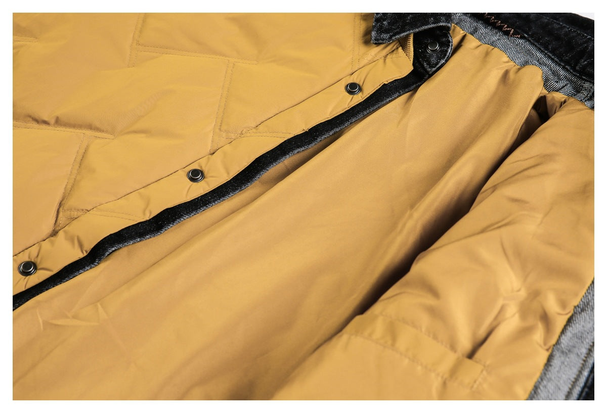 Close-up of a mustard-yellow jacket showing its black inner trim, snap buttons, stitching and gray lining.