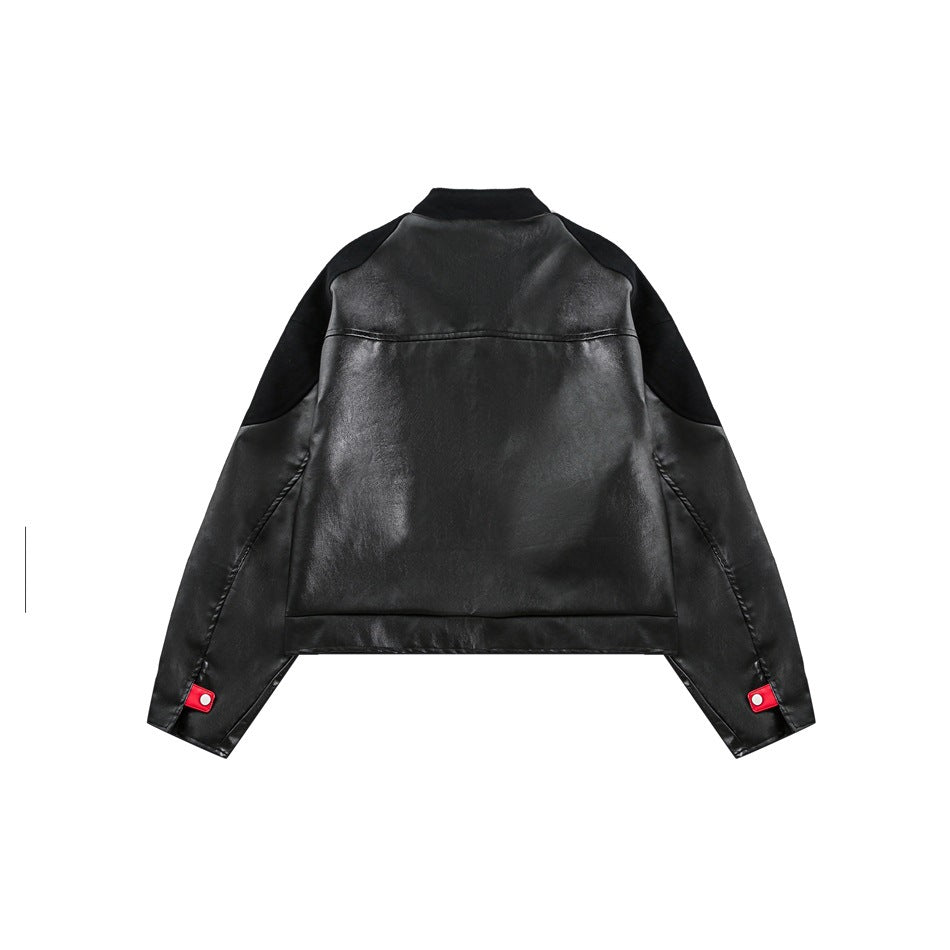 Back view of a black jacket with contrasting shoulder panels and red snap tabs at the cuffs.