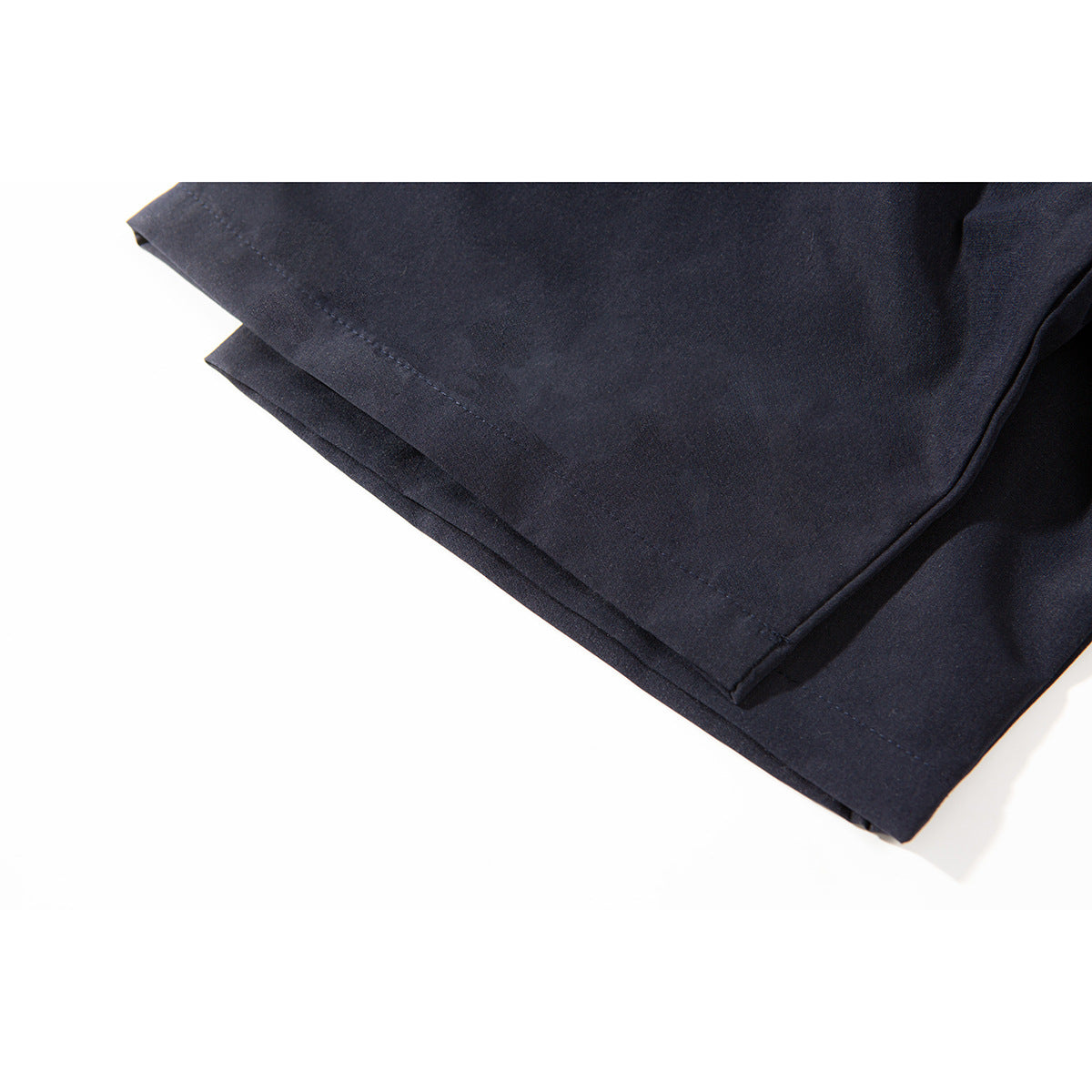 Close-up of the dark navy shirt's short sleeve and stitched hem.