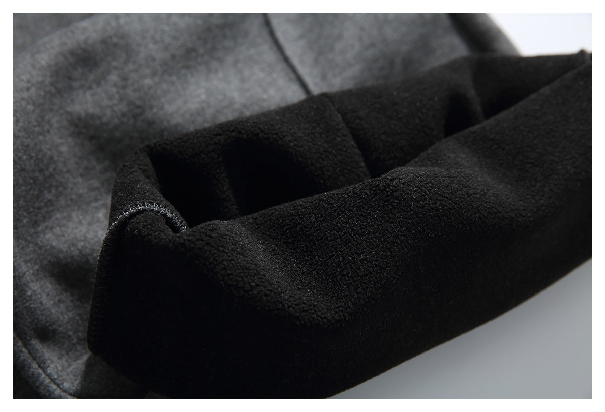Close-up of the black plush inner lining inside a folded charcoal gray pant leg.