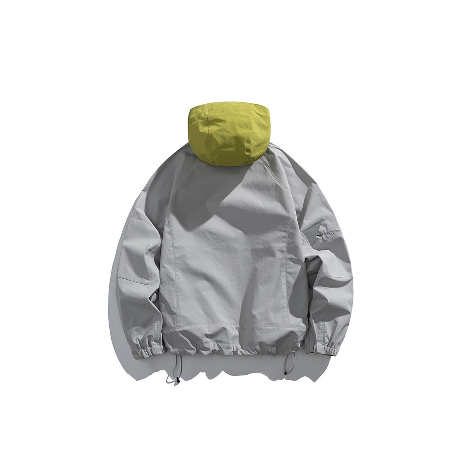 Back view of a light gray jacket with a chartreuse hood, elastic cuffs and hem, and adjustable drawcords.