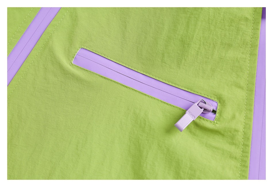 Close-up of a lavender zipper pocket on the lime-green jacket, with matching zipper trim.