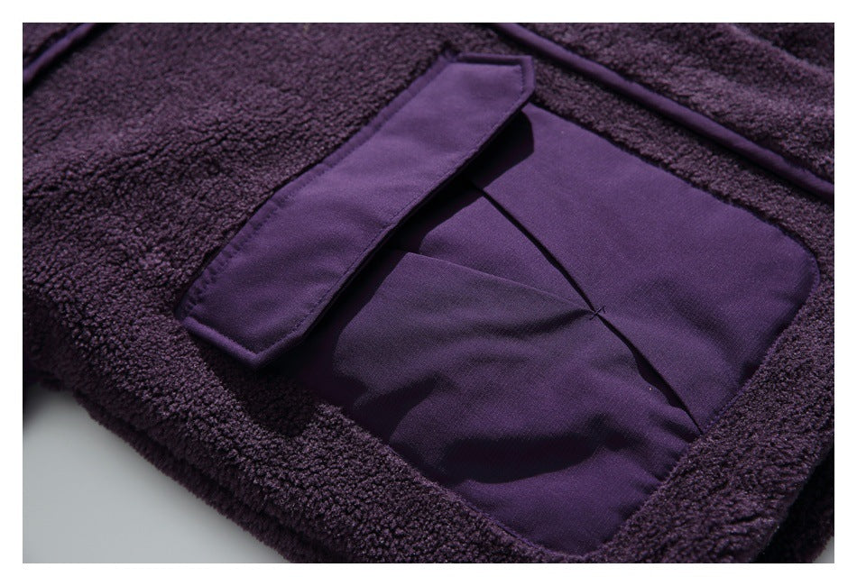 Close-up of a deep purple fuzzy jacket with a smooth fabric pocket and matching flap.