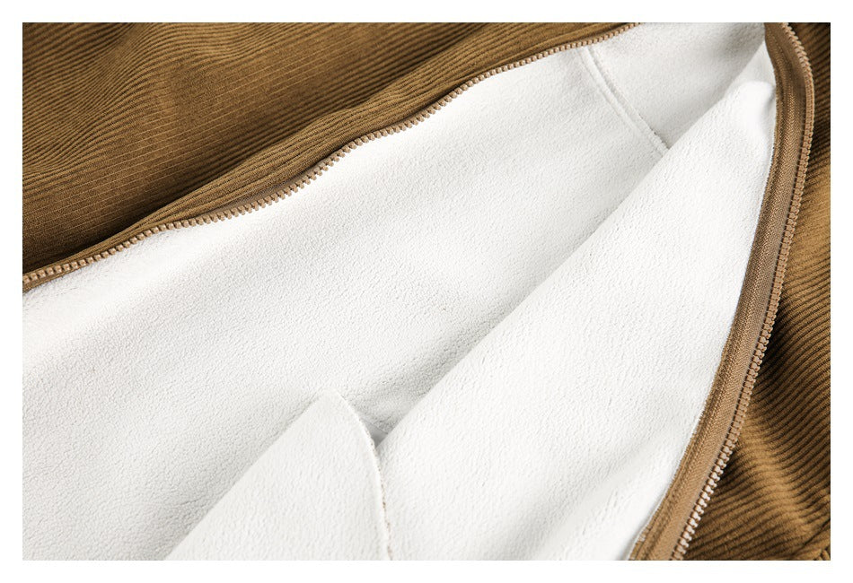 Close-up of a brown jacket opened to show its white fuzzy lining and front zipper.