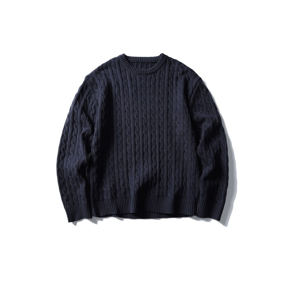 Navy cable-knit crew-neck sweater laid flat, front view