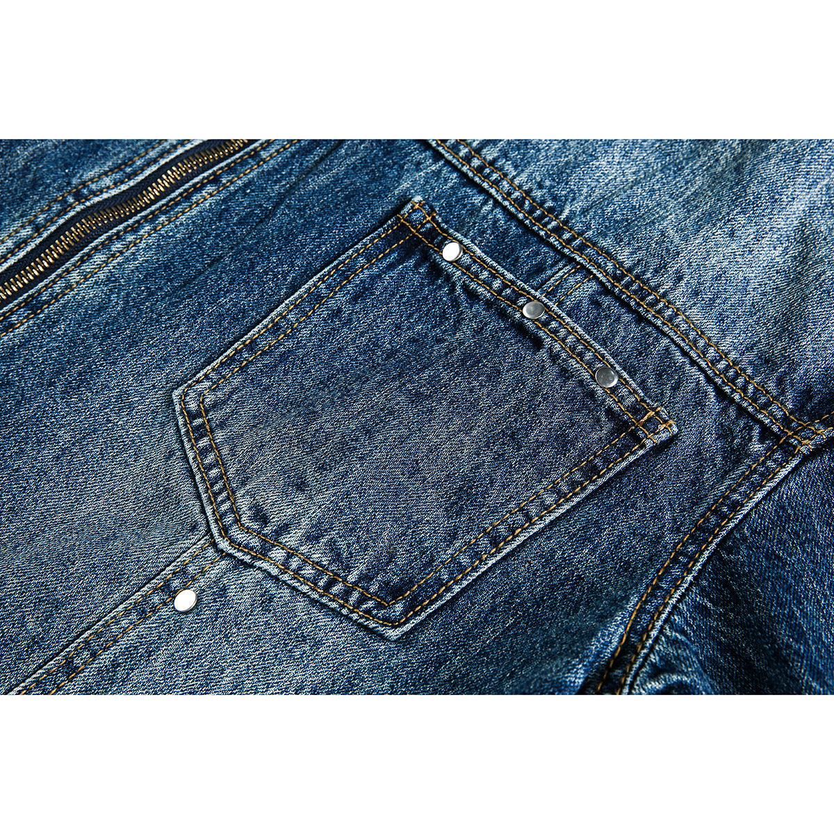 Close-up of a blue denim jacket pocket with metal rivets and contrast stitching.