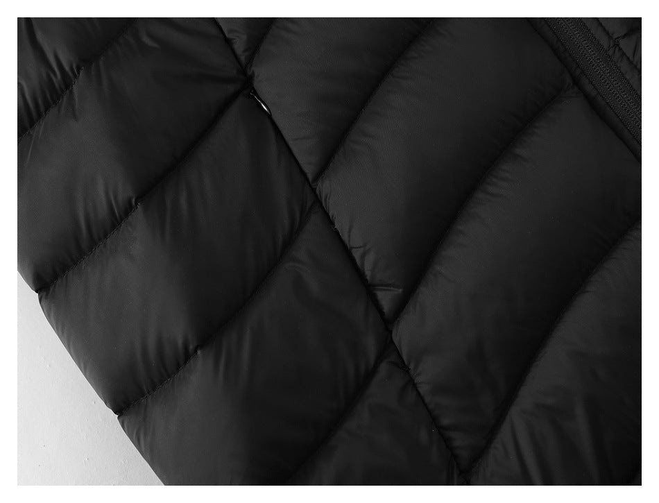 Close-up of the black vest's diagonal quilting and stitched seams.