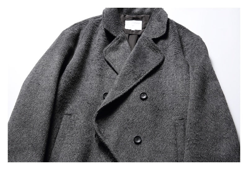 Cropped front view of a dark charcoal gray textured coat with wide lapels and black buttons.