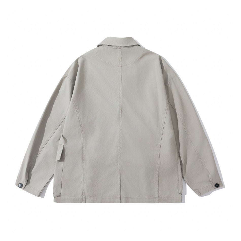 Back view of a light gray-beige jacket laid flat, showing a center seam, notched collar, and buttoned cuffs.