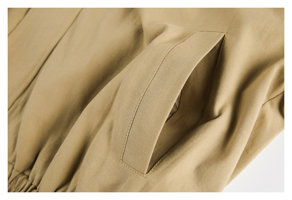Close-up of a slanted pocket opening on tan fabric.