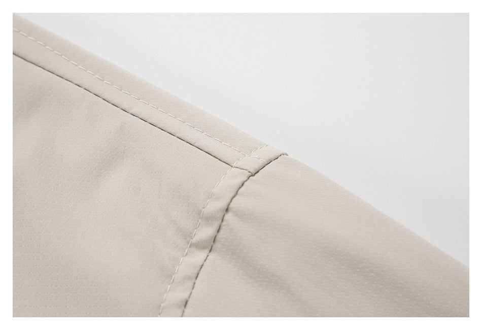 Close-up of stitching and a seam on a light beige garment.
