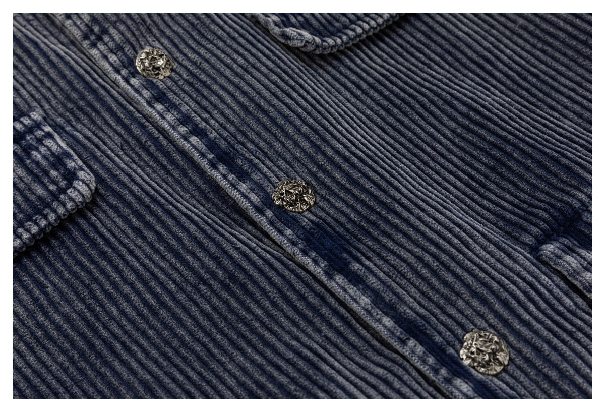 Close-up of the blue-gray ribbed jacket fabric and decorative metal buttons along the front placket.