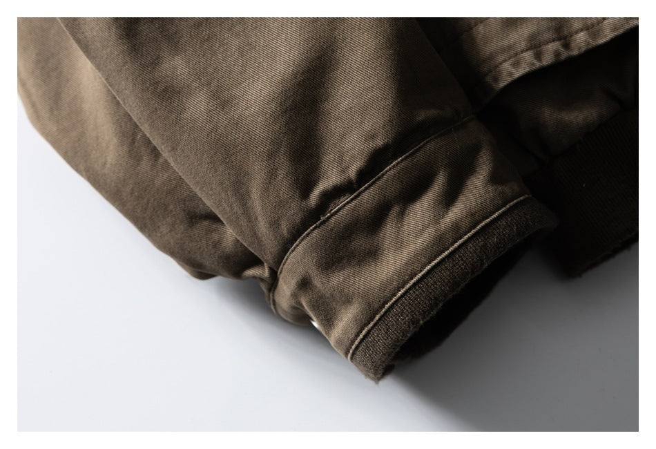 Close-up of a brown jacket sleeve cuff with stitched edging.