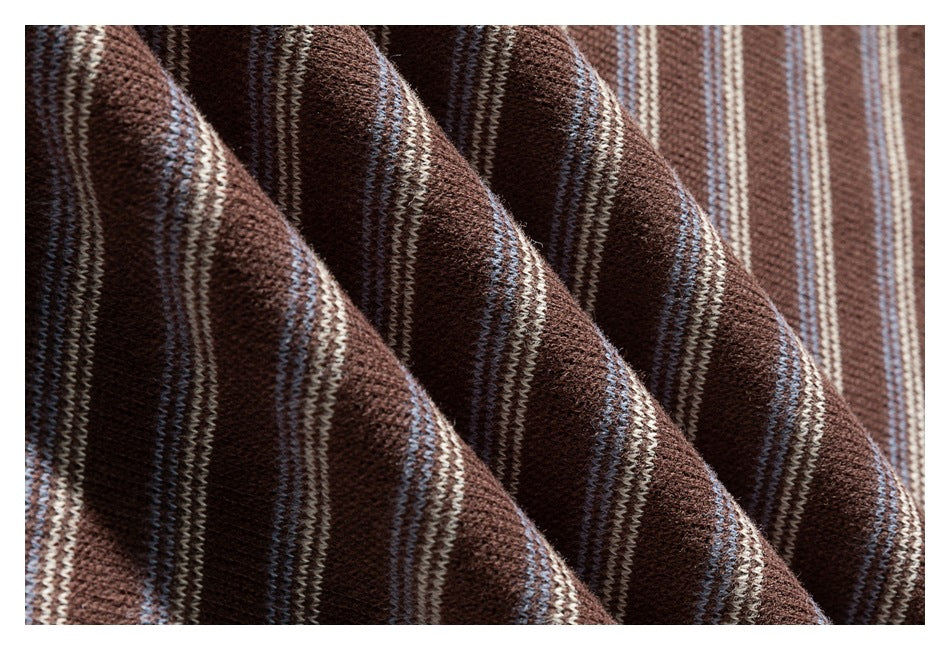 Macro view of the brown knit fabric with narrow cream and pale blue stripes.