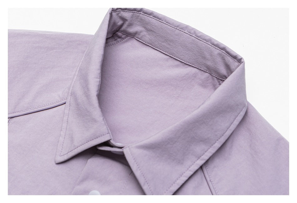 Close-up of the pointed collar and upper front of a pale lavender shirt.