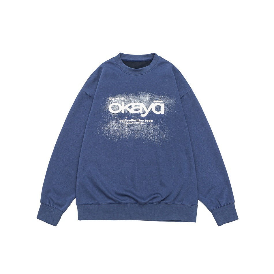 Blue crew-neck sweatshirt flat lay with white distressed okaya chest graphic and ribbed cuffs and hem