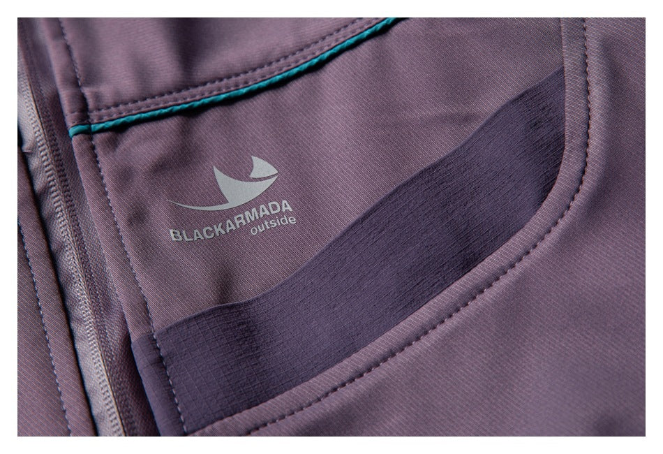 Close-up of a plum jacket interior with teal piping, a dark mesh pocket panel, and a Black Armada logo.