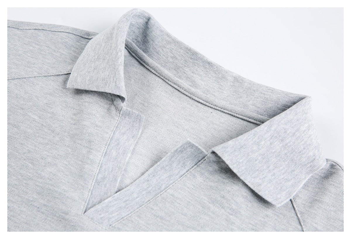 Close-up of a light gray polo shirt collar and open neckline.