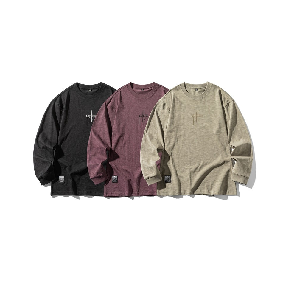 Three long-sleeve shirts shown together in charcoal, plum, and muted sage.