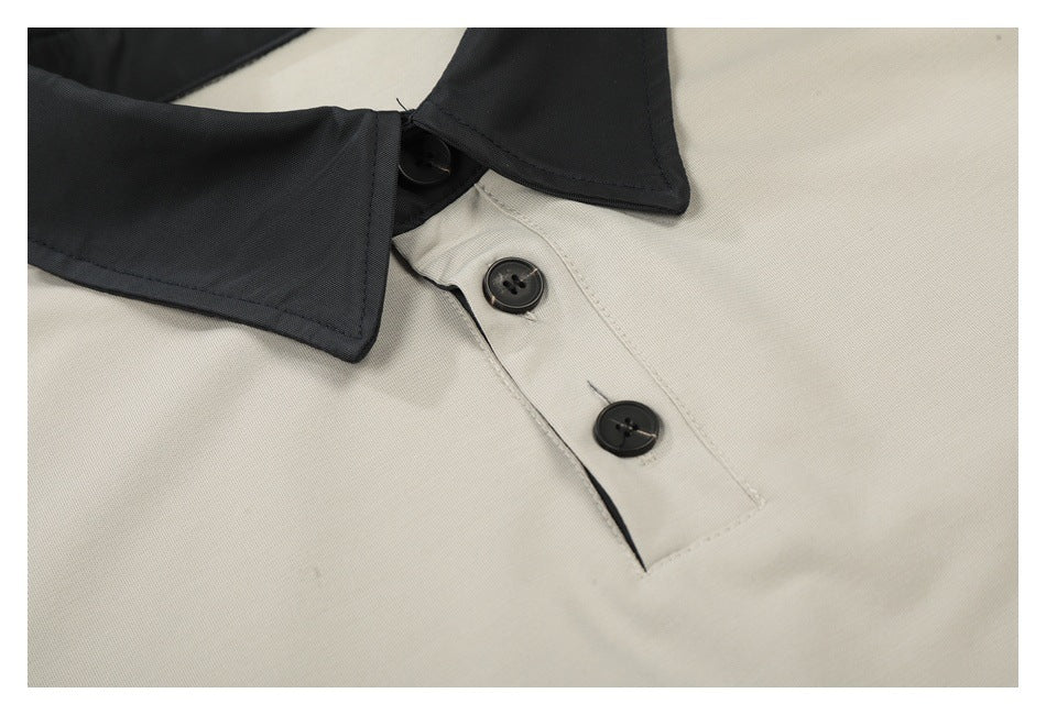 Close-up of the black collar and three-button placket on a light beige polo.