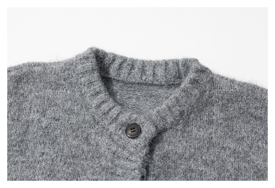 Close-up of the gray cardigan's ribbed collar and dark button.