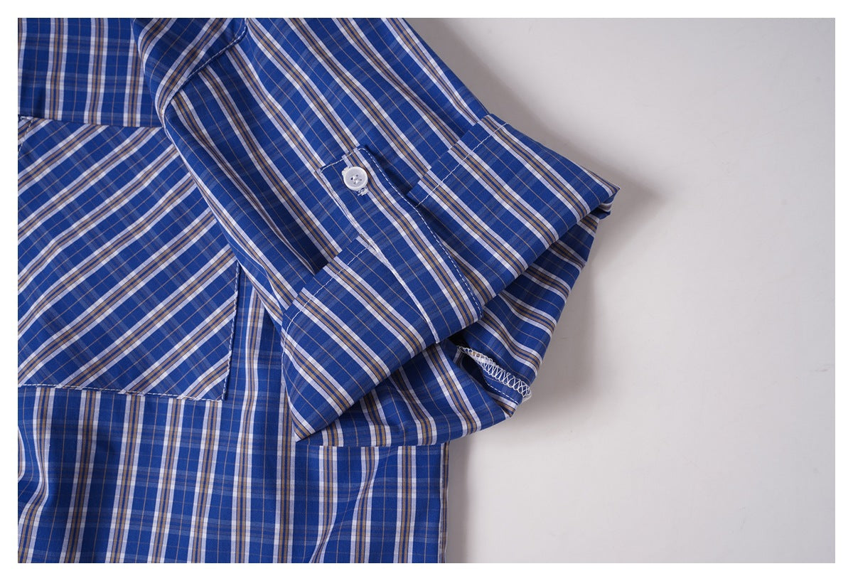 Blue plaid shirt sleeve folded to show its buttoned cuff and stitching.