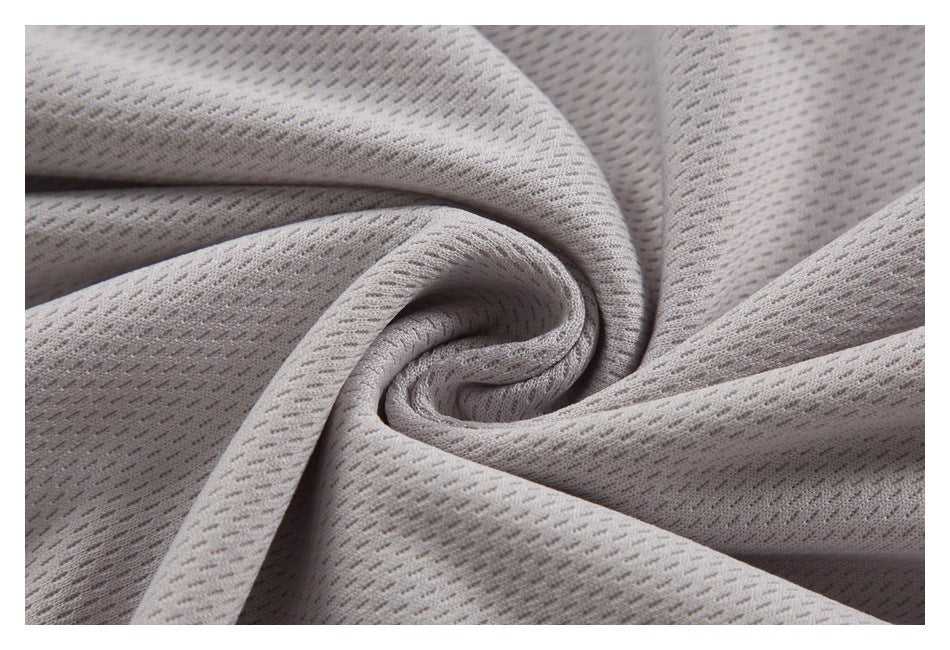 Pale gray patterned mesh fabric gathered into a spiral fold.