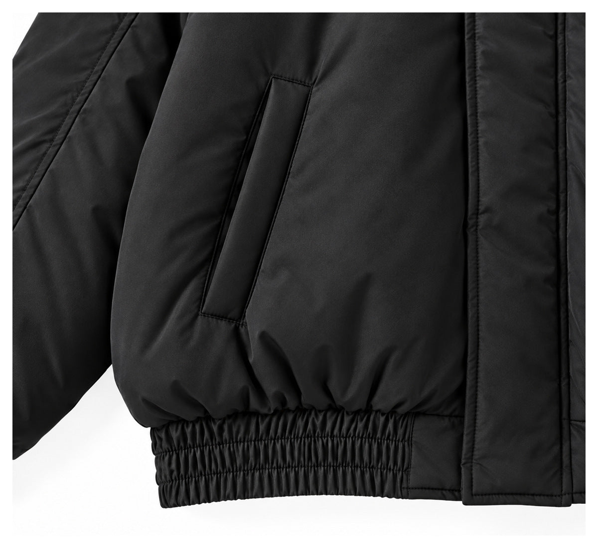 Close-up of a black jacket's vertical welt pocket and gathered elastic waistband.